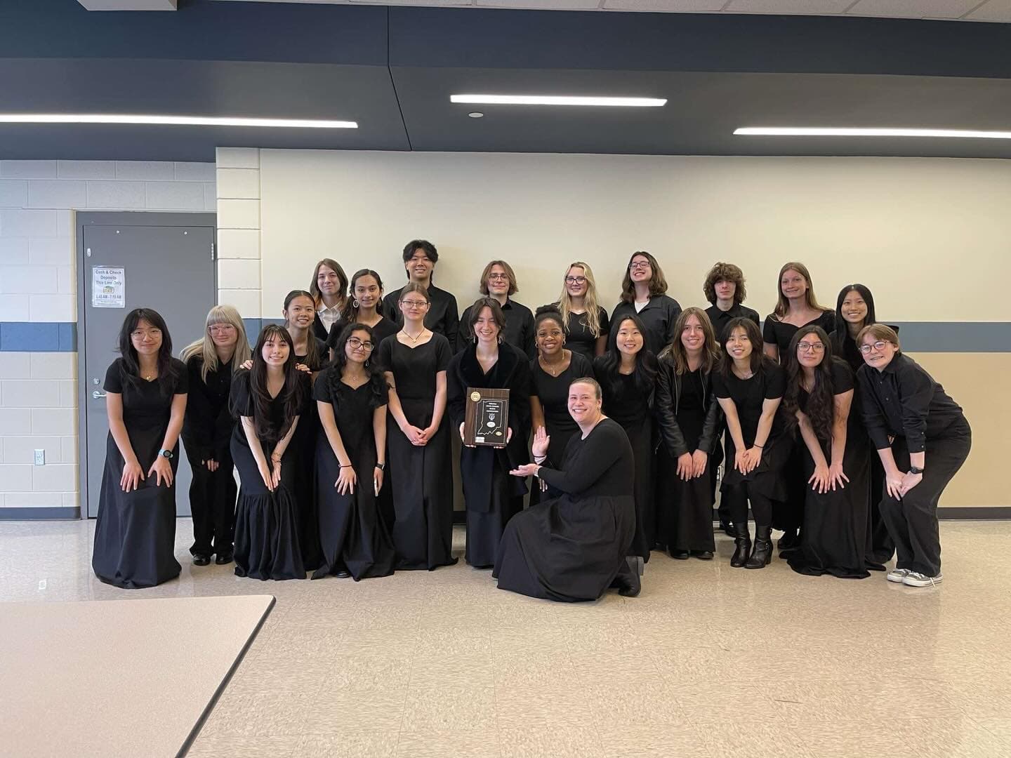 Munster orchestra students in concert black holding their ISSMA award plaque